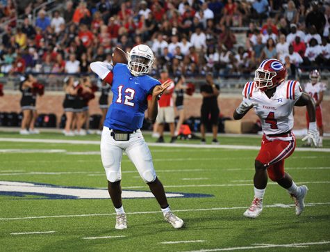 Sophmore QB Grant Tisdale scrambles to his right attempting a pass in the second quarter. 