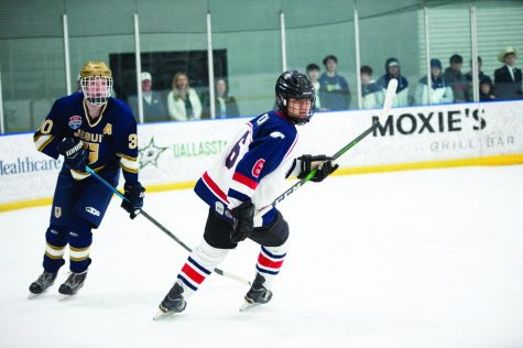 #6 Ethan Chen skates past Jesuit player #30 Luke Skaggs.  