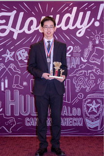 Ethan Zhou at the Texas Junior Science and Humanities Symposium  with his award. 