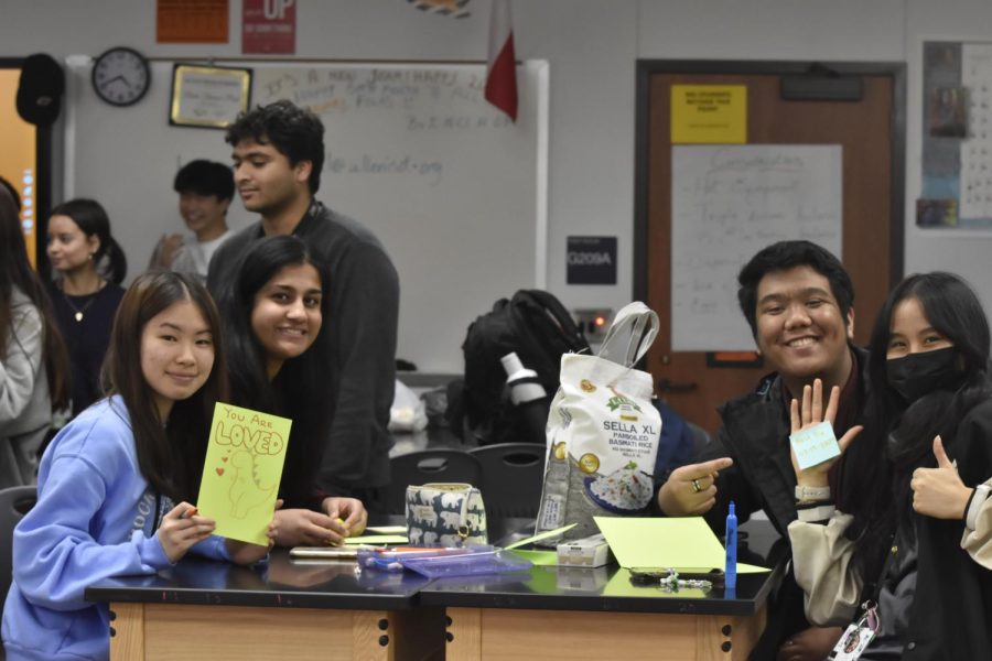 Students in Doctors Without Borders meeting designing cards for donations. 
