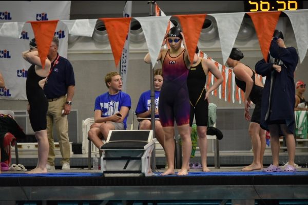 Sophomore Katelynn Zhou preparing herself before swimming the 400 meter freestyle relay.
