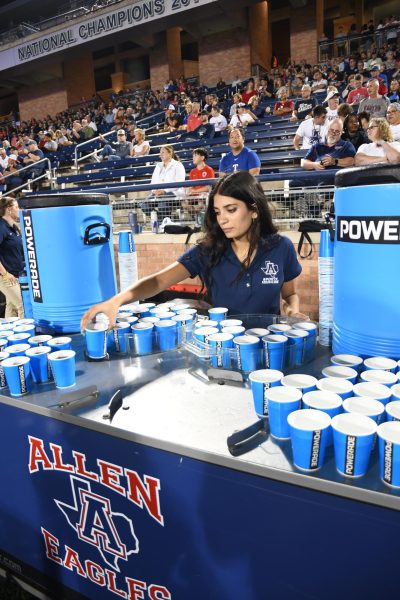 Senior Shipra Chaudhary is filling water cups at the Friday night
football game, Aug. 29, 2025.